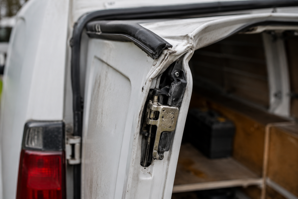 Damaged van door lock from a peel-and-steal tool theft attack